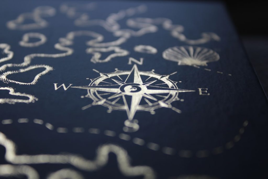 a-close-up-of-a-compass-on-a-table-p8wxsig2i7u